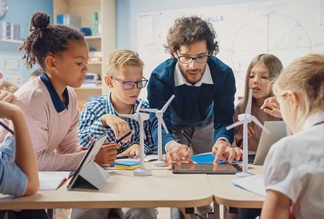 teacher showing students hwo windmills work. science